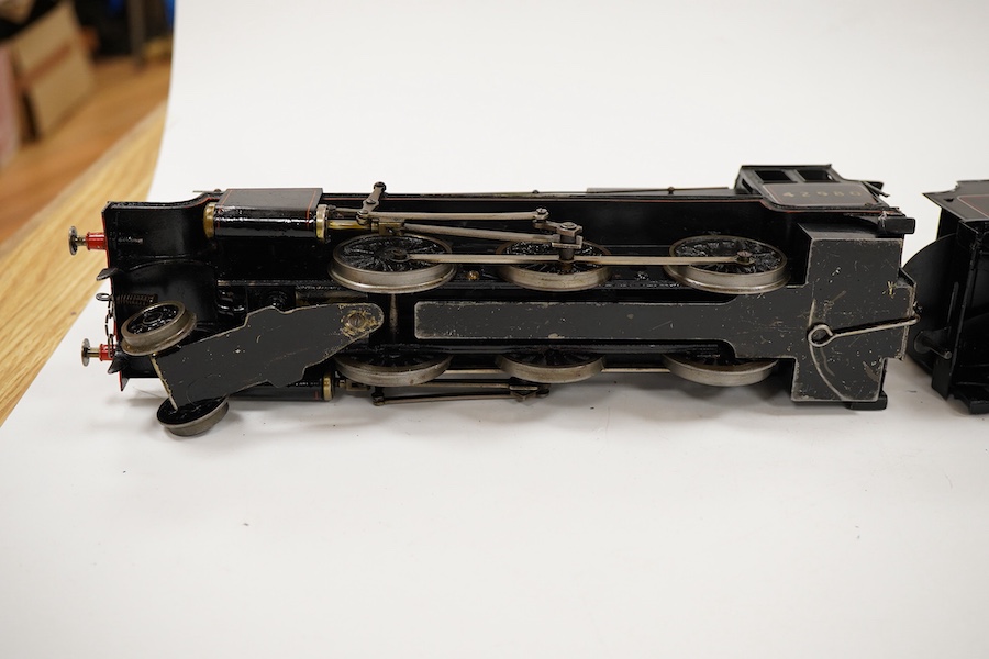 An 0 gauge Bassett-Lowke live steam spirit fired tinplate BR 2-6-0 Mogul tender locomotive, 42980, with original fuel tank and burner, two controls in the cab accessed through the cab roof